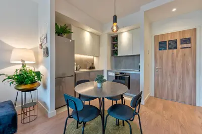 a kitchen and dining room with a table and chairs at ZIGZAG Belgrade Waterfront Aqua in Belgrade