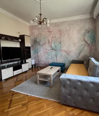 a living room with a couch and a table at Apartman Sasha 1 - Ask for free parking in Sajmište