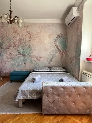 a bedroom with a bed and a wall mural at Apartman Sasha 1 - Ask for free parking in Sajmište
