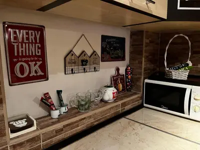a kitchen with a counter with a microwave on a wall at Apartman Sasha 1 - Ask for free parking in Sajmište