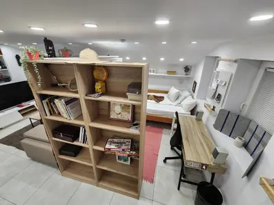 a living room with a room with a couch and a table at Professor's Krunska Studio in Belgrade