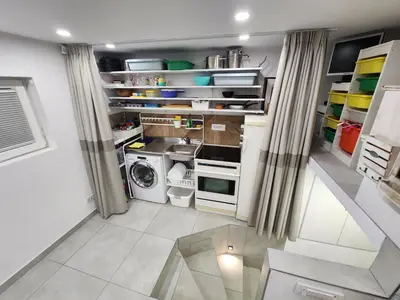 a small kitchen with a washer and dryer at Professor's Krunska Studio in Belgrade