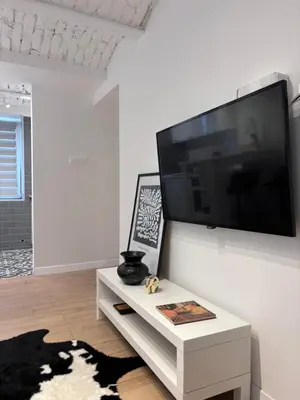 a living room with a large flat screen tv on a wall at HUGO OLD TOWN in Belgrade
