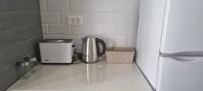 a coffeemaker sitting on a tile floor in a kitchen at HUGO OLD TOWN in Belgrade