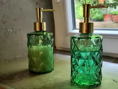 two green glass bottles sitting on a table at HUGO OLD TOWN in Belgrade