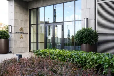 a building with glass doors and plants in front of it at inJoy in Belgrade