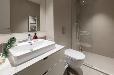 a white bathroom with a sink and a toilet at inJoy in Belgrade