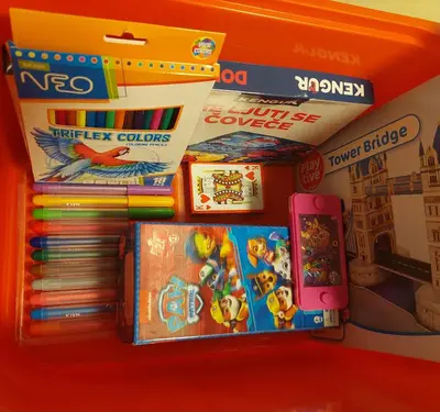 a pile of games and books on a shelf at Charna apartment Beograd Železnik in Železnik