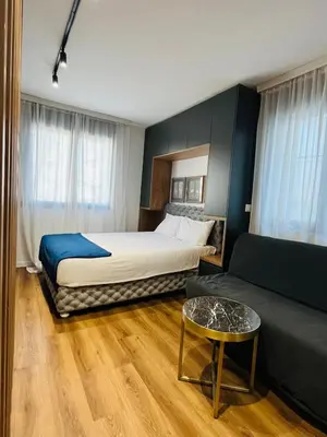a hotel room with a bed and a couch at Parliament Studio Appartment in Belgrade