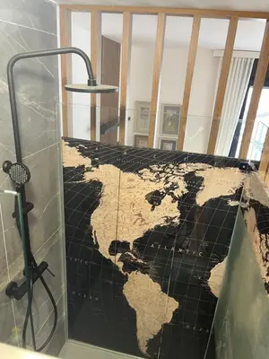 a map of the world on a wall in a bathroom at Parliament Studio Appartment in Belgrade