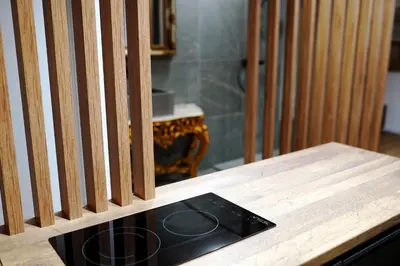 a wooden table with a black object on top of it at Parliament Studio Appartment in Belgrade