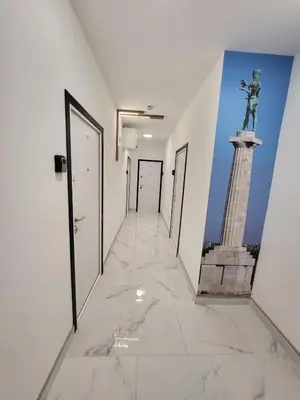 a corridor with a statue in the middle of a building at HARMONY Suites (Savska ulica) in Sajmište