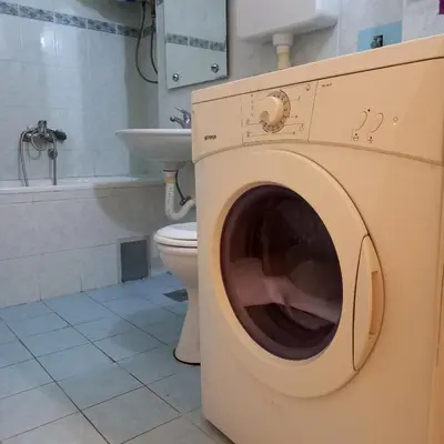 a washing machine in a bathroom with a toilet at RIVIJERA LAKES Ada Studio in Belgrade