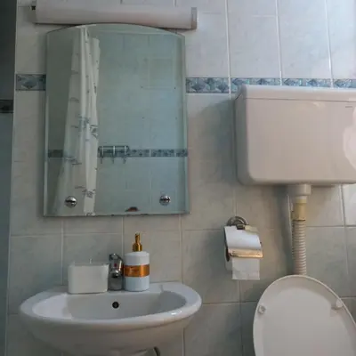 a bathroom with a sink and a mirror and a toilet at RIVIJERA LAKES Ada Studio in Belgrade