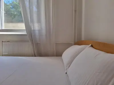 a white bed with a window in a bedroom at RIVIJERA LAKES Ada Studio in Belgrade