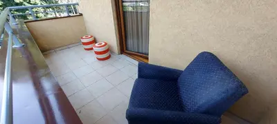 a blue chair sitting on a balcony next to a window at RubiCon Apartments in Belgrade