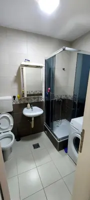 a bathroom with a shower and a toilet and a sink at RubiCon Apartments in Belgrade