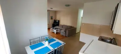 a kitchen and living room with a table and a couch at RubiCon Apartments in Belgrade