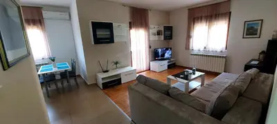 a living room with a couch and a tv at RubiCon Apartments in Belgrade