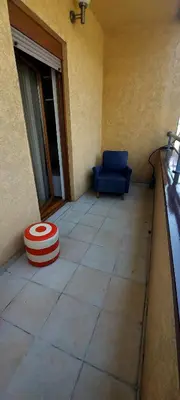 a room with a blue chair and a red ottoman at RubiCon Apartments in Belgrade