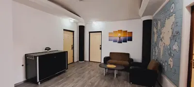 a living room with a tv and a couch and a chair at Magellan Apartments in Belgrade