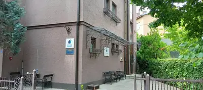 a building with tables and chairs on the side of it at Magellan Apartments in Belgrade