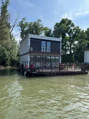 a house on a dock on a river at Floating Zen House in Belgrade