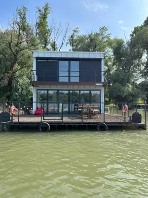 a house on a dock on a body of water at Floating Zen House in Belgrade