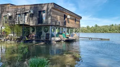 a house on a dock on a body of water at Floating Zen House in Belgrade