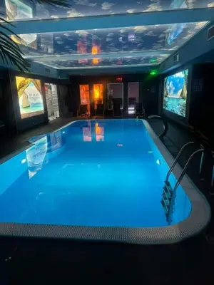 a large swimming pool in a large room at Bella apartman in Mladenovac