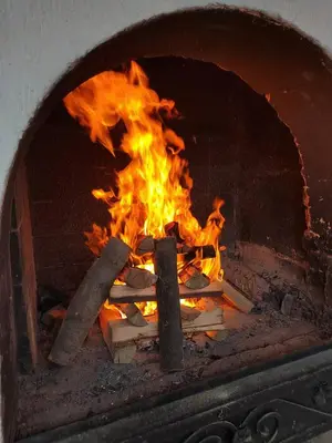 a fire inside of a brick oven with flames at Apartman u potkrovlju in Sremski Karlovci