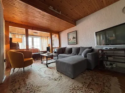 a living room with a couch and a flat screen tv at Apartman u potkrovlju in Sremski Karlovci