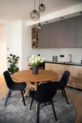 a kitchen with a wooden table and two chairs and a kitchen at Belgrade Waterfront Sunshine apartment in Belgrade