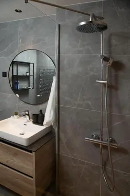 a bathroom with a sink and a shower with a mirror at Belgrade Waterfront Sunshine apartment in Belgrade