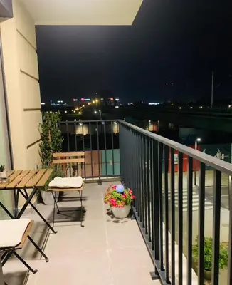 a balcony with tables and chairs on a building at Belgrade Waterfront Sunshine apartment in Belgrade