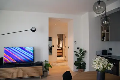 a living room with a flat screen tv on a wooden entertainment center at Belgrade Waterfront Sunshine apartment in Belgrade