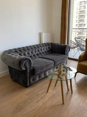a living room with a couch and a glass table at Verde 18 in Sajmište