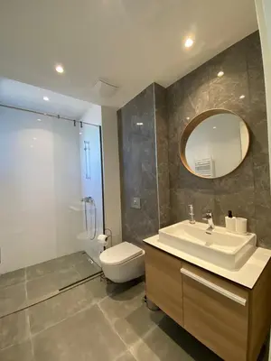 a bathroom with a sink and a toilet and a mirror at Verde 18 in Sajmište