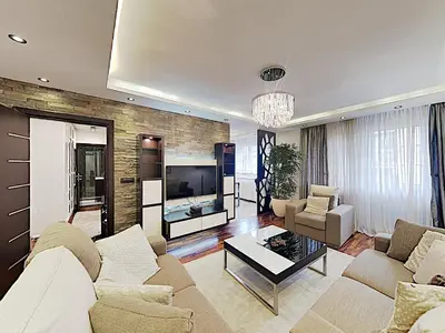 a living room with a couch and a tv at ETNOGRAF in Belgrade