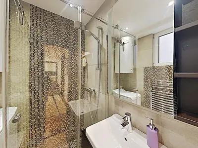 a bathroom with a sink and a glass shower at ETNOGRAF in Belgrade