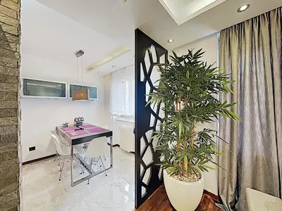 a living room with a table and a plant at ETNOGRAF in Belgrade