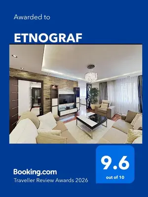 a living room with two couches and a tv at ETNOGRAF in Belgrade