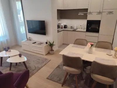 a living room with a table and a kitchen at Kalemegdan Park Residence - new luxury apartment in Belgrade