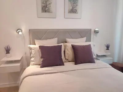 a bedroom with a large bed with purple pillows at Kalemegdan Park Residence - new luxury apartment in Belgrade