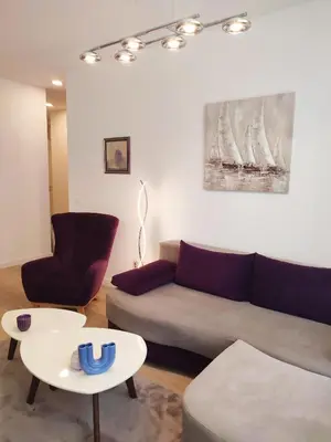 a living room with a couch and a table at Kalemegdan Park Residence - new luxury apartment in Belgrade
