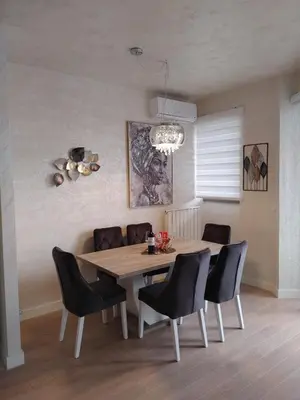 a dining room with a table and chairs at GIGI Apartment in Belgrade