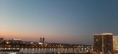 a city skyline at night with a river and buildings at GIGI Apartment in Belgrade