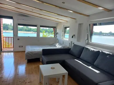 a living room with a couch and a bed at Island Ada in Čukarica