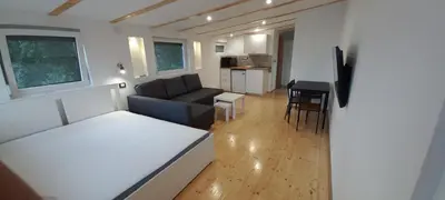 a living room with a couch and a table at Island Ada in Čukarica