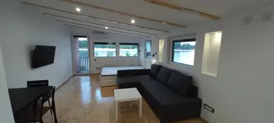 a living room with a couch and a bed at Island Ada in Čukarica
